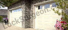 Newly installed beige residential garage doors Ft Saskatchewan.