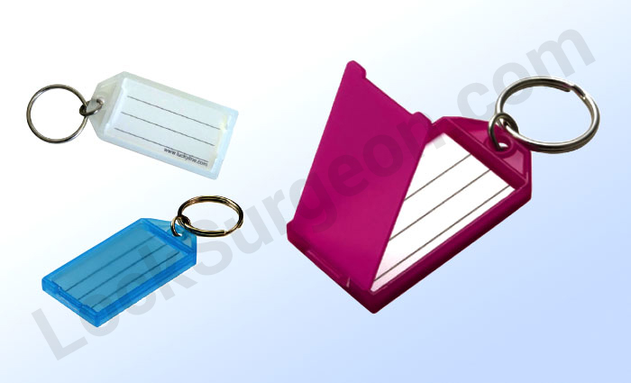 Open and close flat clicks over paper insert for identification with key ring attached.
