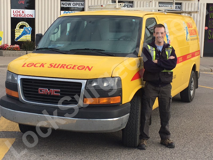 Apprentice Phil standing by Lock Surgeon service truck in Calgary.
