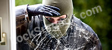 Burglar looking in through a shattered window.