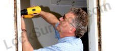 Door repair and installation technician fixing broken door Calgary.