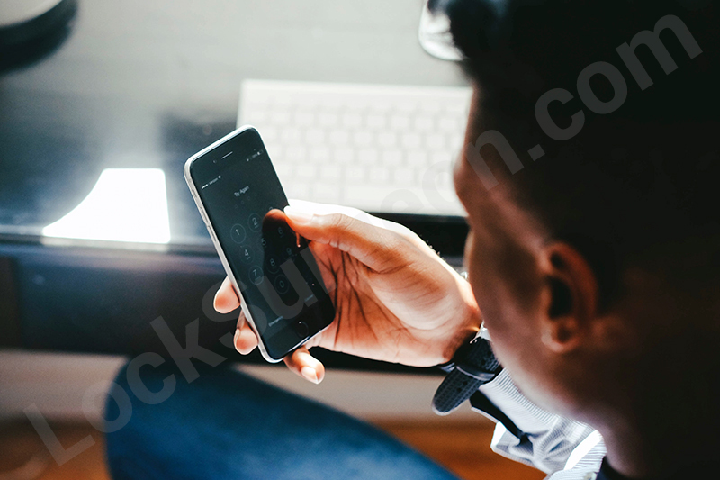 Cell phone user accessing bluetooth access control app with smartphone.