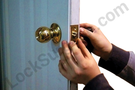 locksmith repairing door latch.