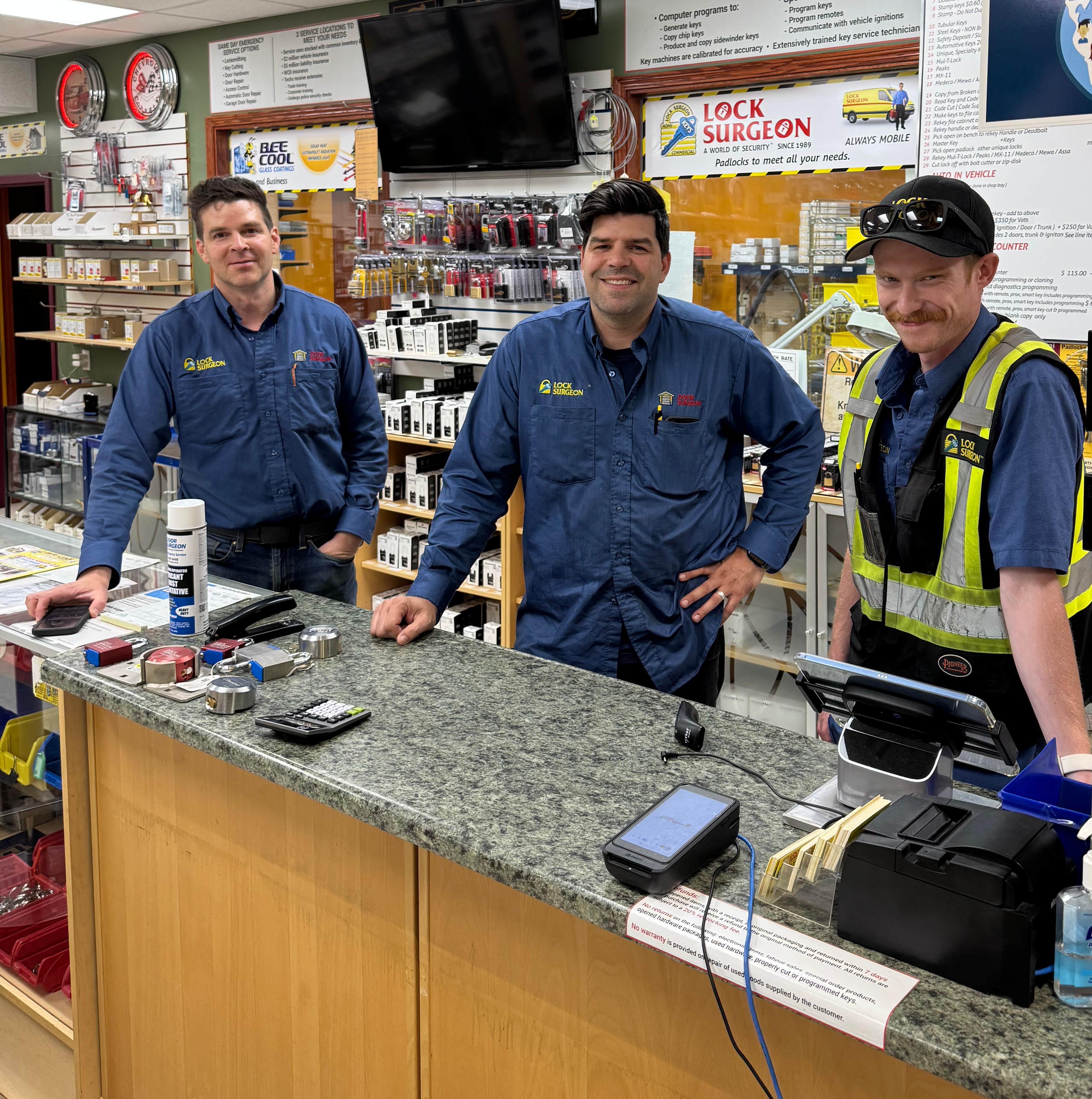 Patrick, Paul and Lucas at locksmith shop key cutting & hardware parts service counter