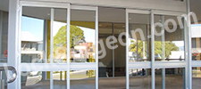 Open sliding glass doors on a commercial building Leduc.