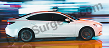 white car racing down a street.