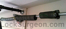 Broken garage door spring requiring repair Sherwood Park.