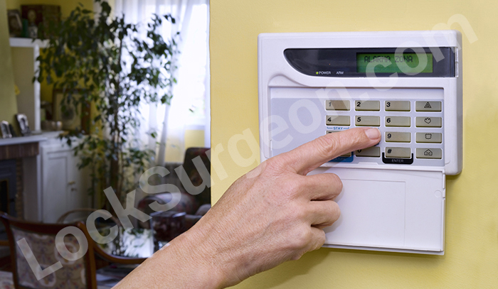 Resident using wallmount security keypad.