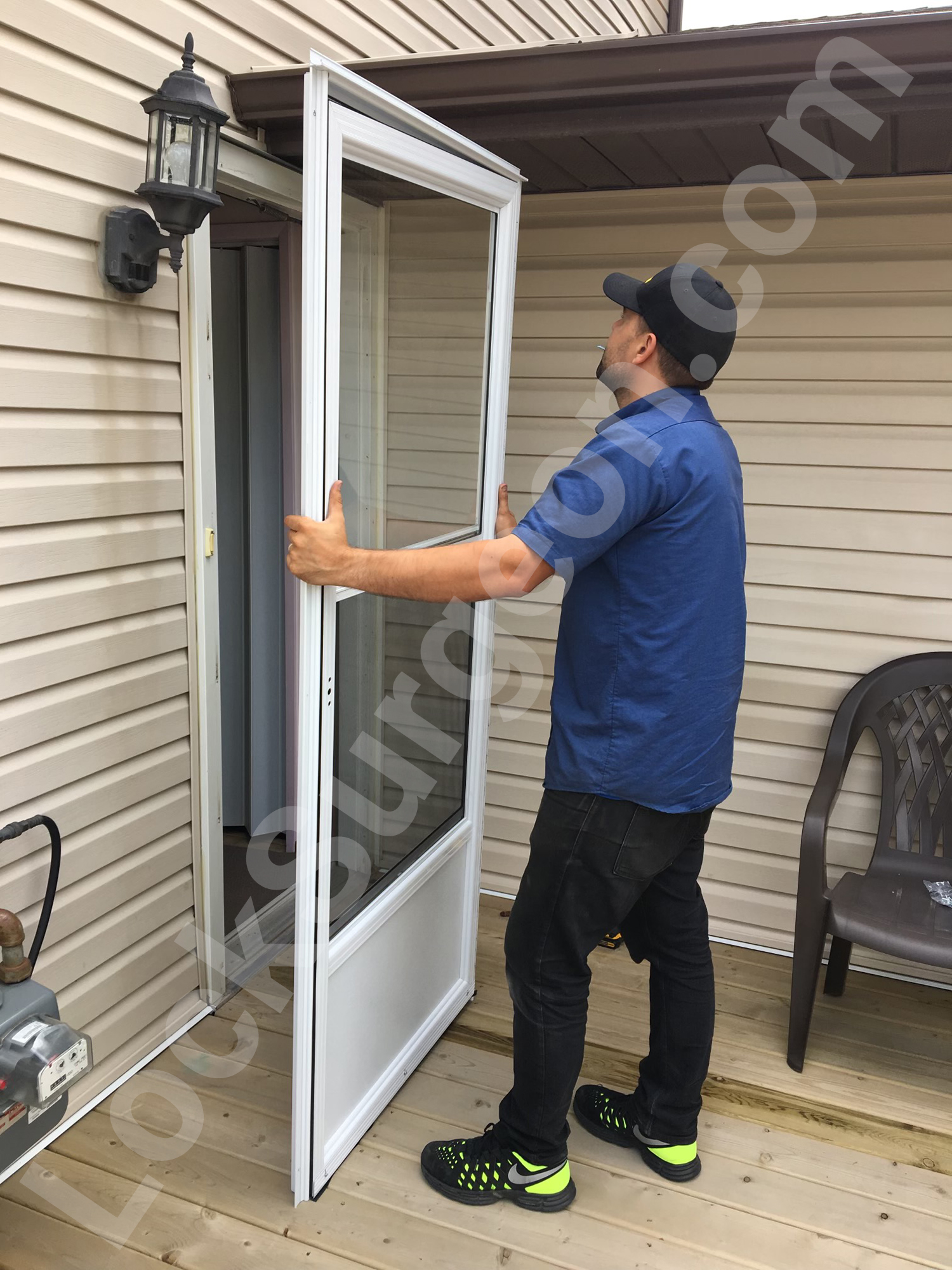 New storm door installation process by Lock Surgeon technician.