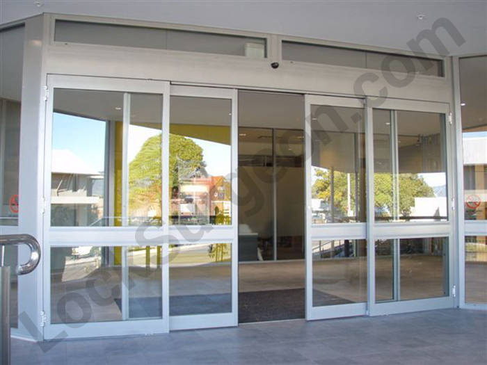 Sliding glass industrial doors on building half open.